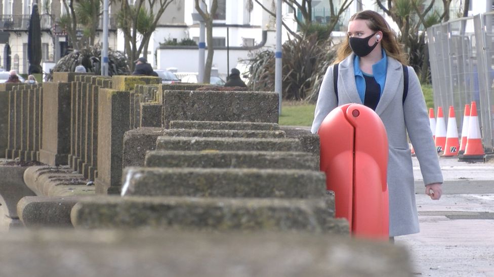 Woman walking along Douglas promenade