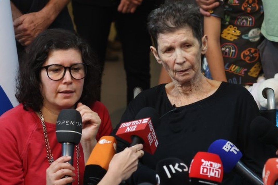 Yocheved Lifschitz (C), 85, speaks with the media next to her daughter Sharone