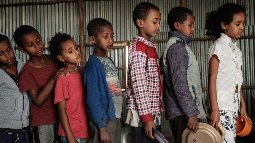 Children, who fled the violence in Ethiopia's, Tigray region, wait in line for breakfast organized by a self-volunteer Mahlet Tadesse, 27, in Mekele, the capital of Tigray region, on June 23, 2021