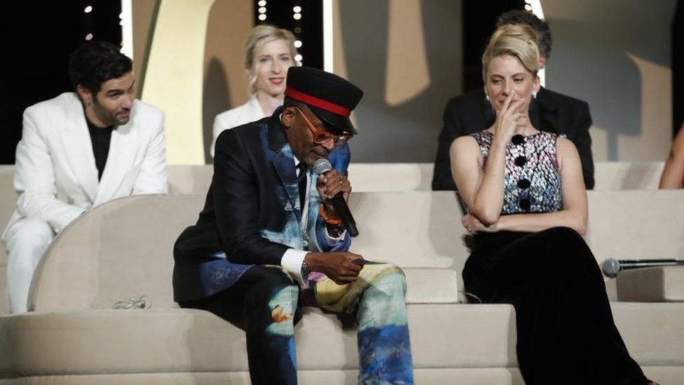 Spike Lee speaks on stage next to other members of the jury during the Closing Awards Ceremony