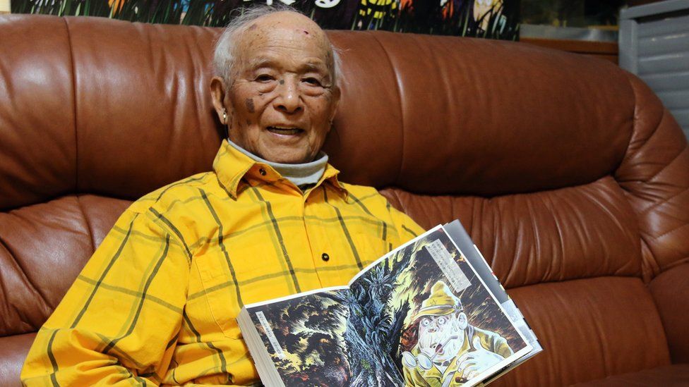 Japanese manga artist Shigeru Mizuki displays his graphic novel 'Complete Collection of Shigeru Mizuki's Manga Works - Showa: A History of Japan' at his studio in Tokyo