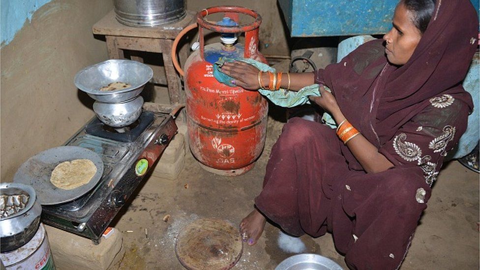In this photograph taken on April 9, 2019, an Indian labourer arranges liquid petroleum gas (LPG) cylinders at a distribution centre in Patna. - Reena Devi says her life changed when she got a cooking gas connection under a programme championed by India's Prime Minister Narendra Modi.