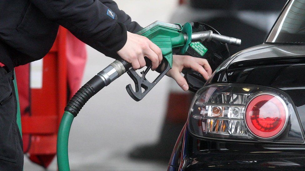 Motorist using a petrol pump