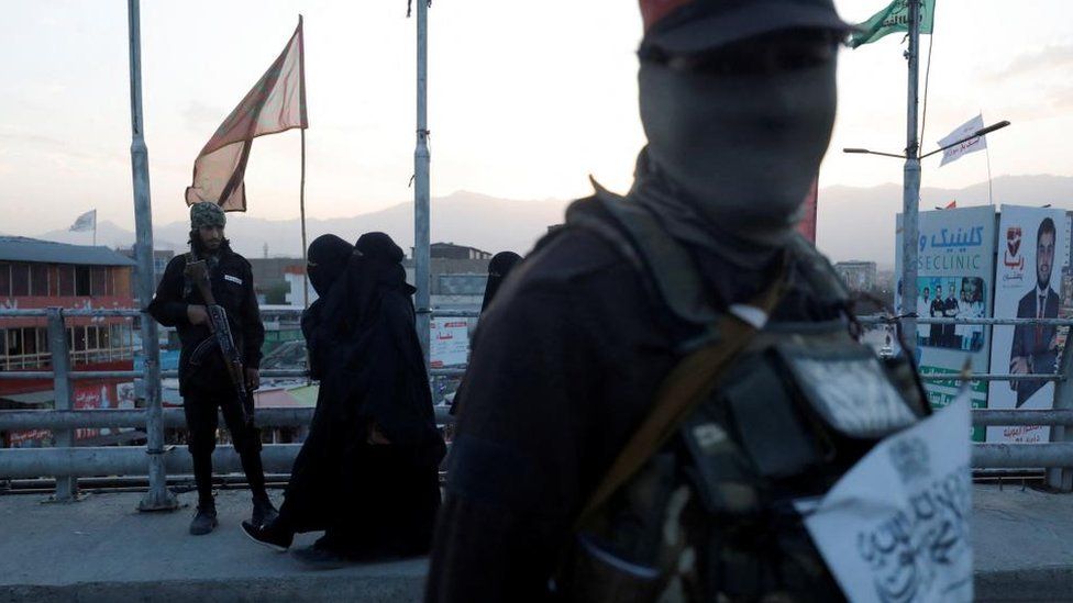 Taliban fighters stand guard on a bridge in Kabul, Afghanistan