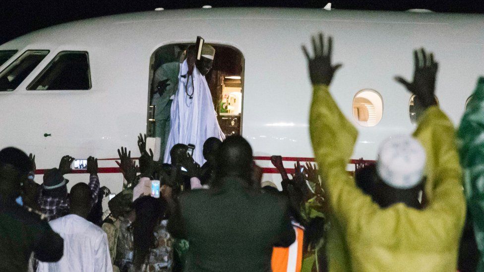 Former president Yaya Jammeh (C,up), the Gambia's leader for 22 years, waves from the plane as he leaves the country on 21 January 2017 in Banjul