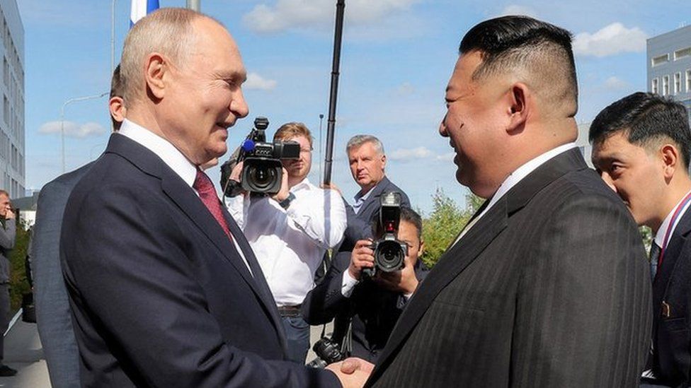Kim Jong Un and Vladimir Putin shaking hands