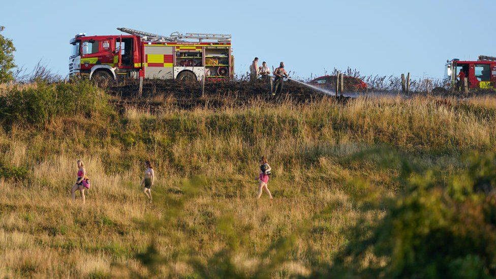 Fire crews from Cleveland Fire and Rescue services tackle a crop fire that swept over farmland in Redcar and Cleveland, North Yorkshire