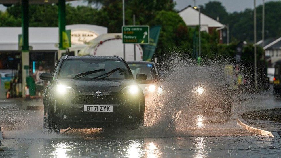 Vehicles are driven done  flash flooding successful  the Lower Wick country  of Worcester aft  an day  of thunderstorms.