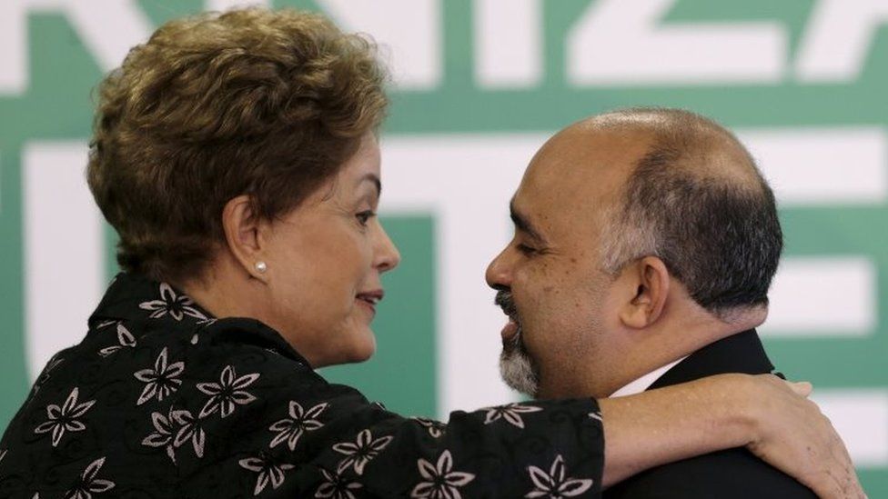 President Dilma Rousseff (L) greets Sports Minister George Hilton during a ceremony to announce measures to modernize Brazilian soccer at the Planalto Palace in Brasilia, Brazil, in this March 19, 2015 file photo.