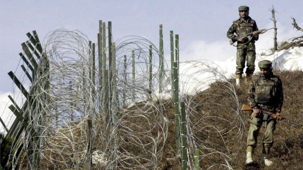 This file photograph taken on December 4, 2003, shows Indian soldiers as they patrol along a barbed-wire fence near Baras Post on the Line of Control (LoC) between Pakistan and India some 174 kms north west of Srinagar.