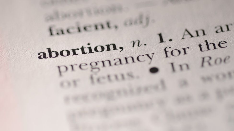 The word 'abortion' highlighted in a dictionary