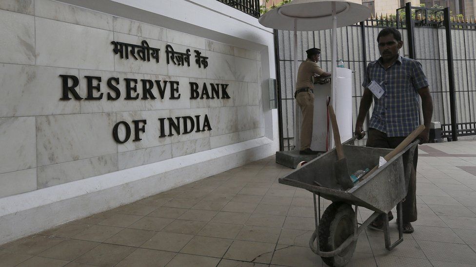 A worker pushes a wheelbarrow inside the Reserve Bank of India head office in Mumbai, India, 5 April