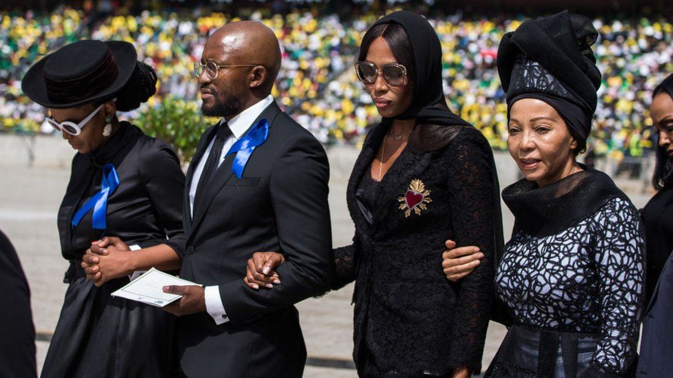 British super model Naomi Campbell walks with members of the Mandela family during the funeral of anti-apartheid icon Winnie Madikizela-Mandela at the Orlando Stadium in the township of Soweto, concluding 10 days of national mourning on April 14, 2018, in Johannesburg.