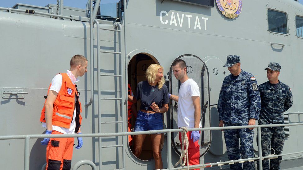 British tourist Kay Longstaff (C) exits Croatia's coast guard ship in Pula, on August 20, 2018, which saved her after falling off a cruise ship near Croatian coast
