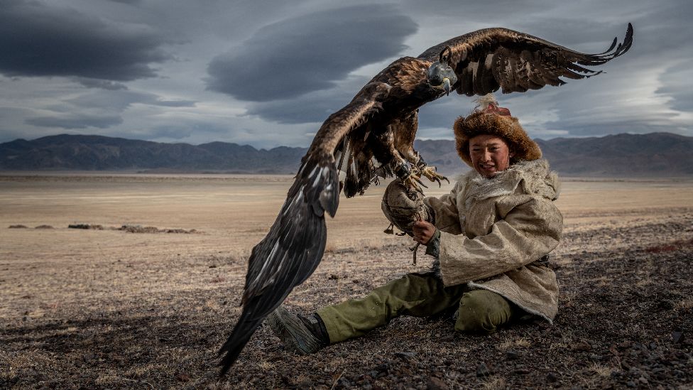 Child holding an eagle in Mongolia