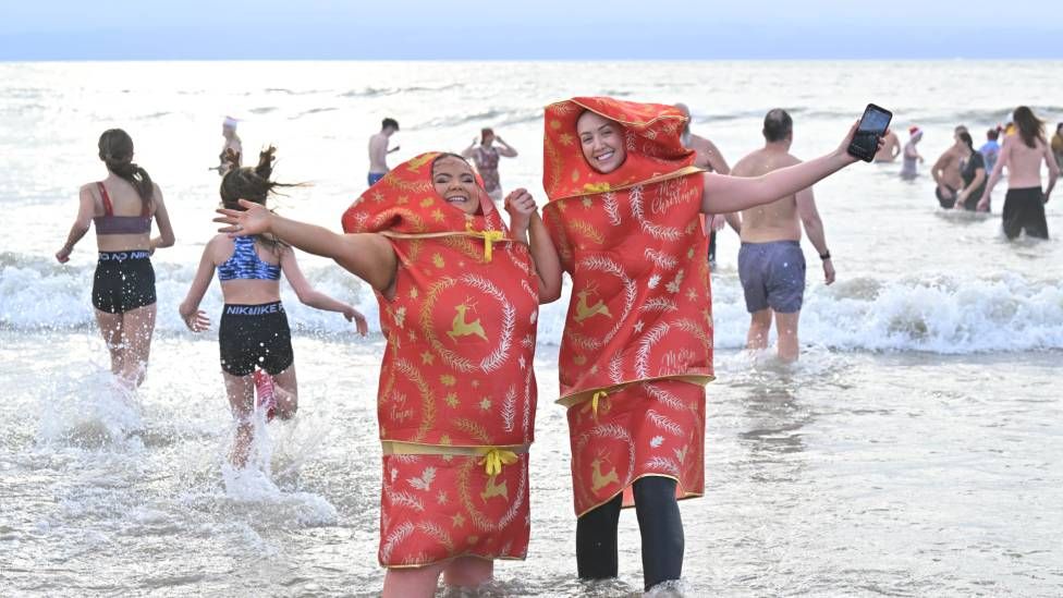 swimmers in fancy dress in sea