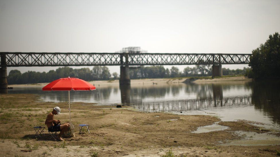 People cool off in the River Po near the Ponte della Becca bridge in Linarolo, near Pavia, northern Italy, 1 August
