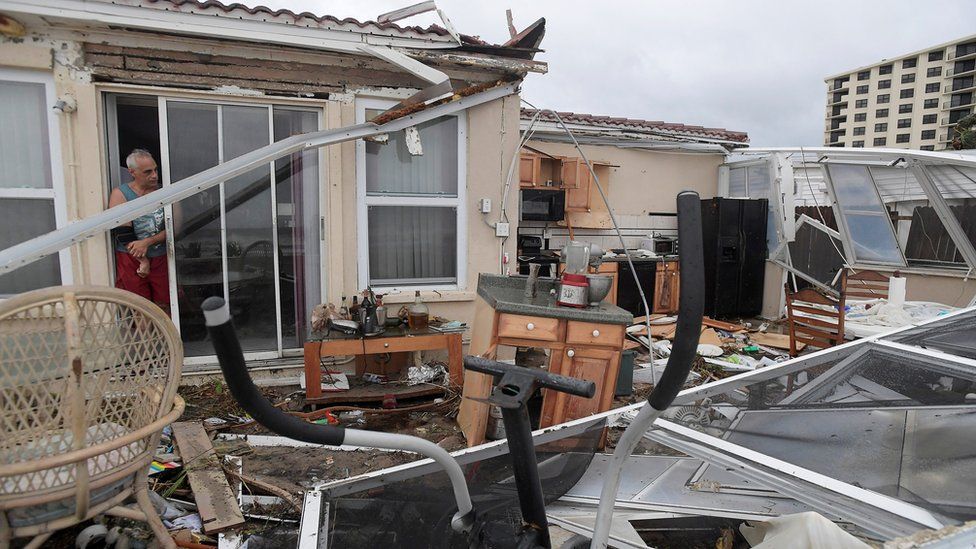 Homeowner Joe Lovece surveys the damage to the kitchen at the back of his home in Ormond Beach, Florida, 7 October.