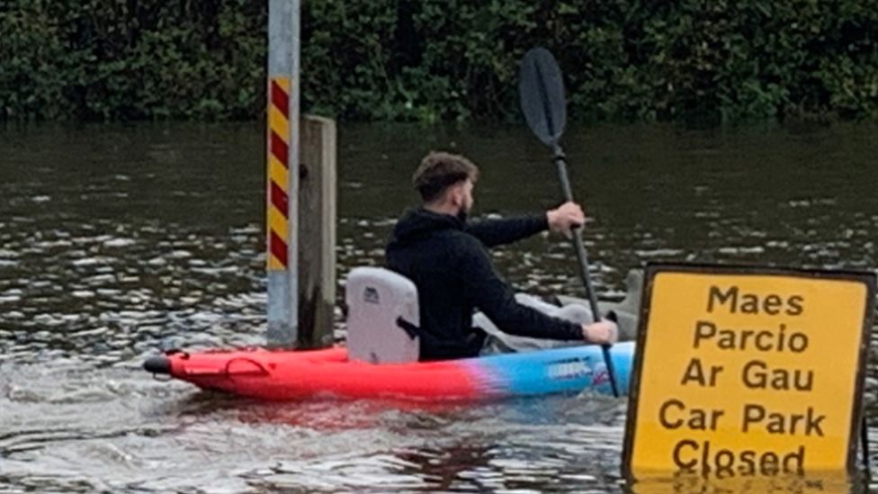 Kayaker in flooded car park