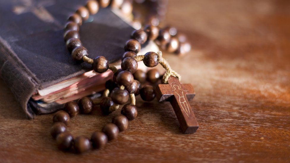 A generic image of a bible and a cross