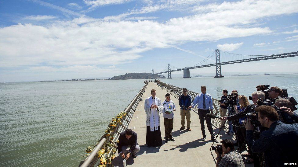 Father Cameron Faller leads a prayer vigil for shooting victim Kathryn Steinle on Pier 14 in San Francisco - 6 July 2015
