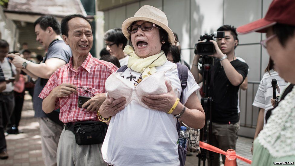 Protester wearing fake breasts in Wan Chai, Hong Kong (2 Aug 2015)