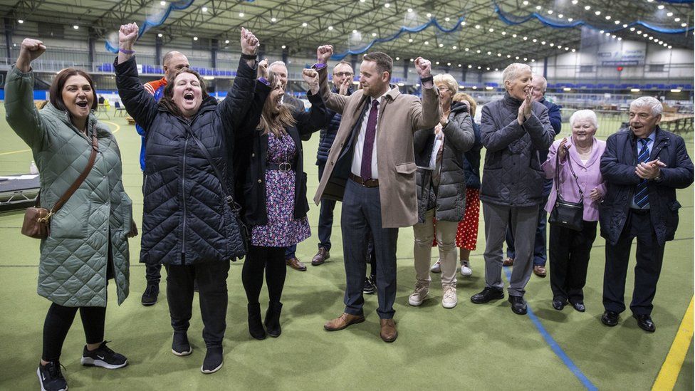 The DUP's Gary Middleton (centre) won the last seat at Stormont on Sunday morning