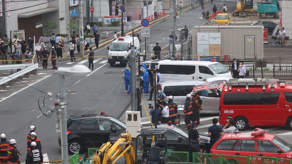 A general view shows workers at the scene after the attack on Japan's former prime minister Shinzo Abe at Kintetsu Yamato-Saidaiji station square in Nara on July 8