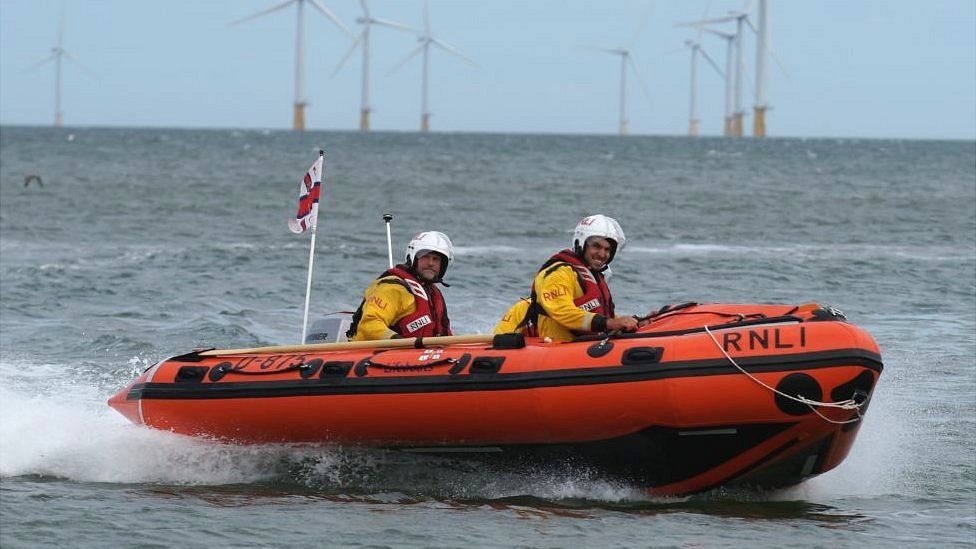 RNLI lifeboat crew on a dinghy