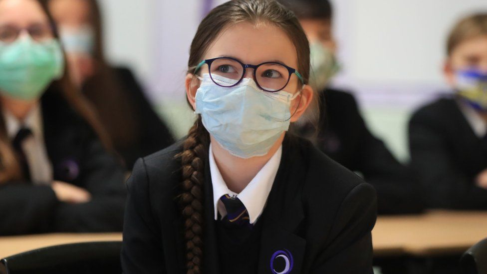 Girl in classroom wearing a mask