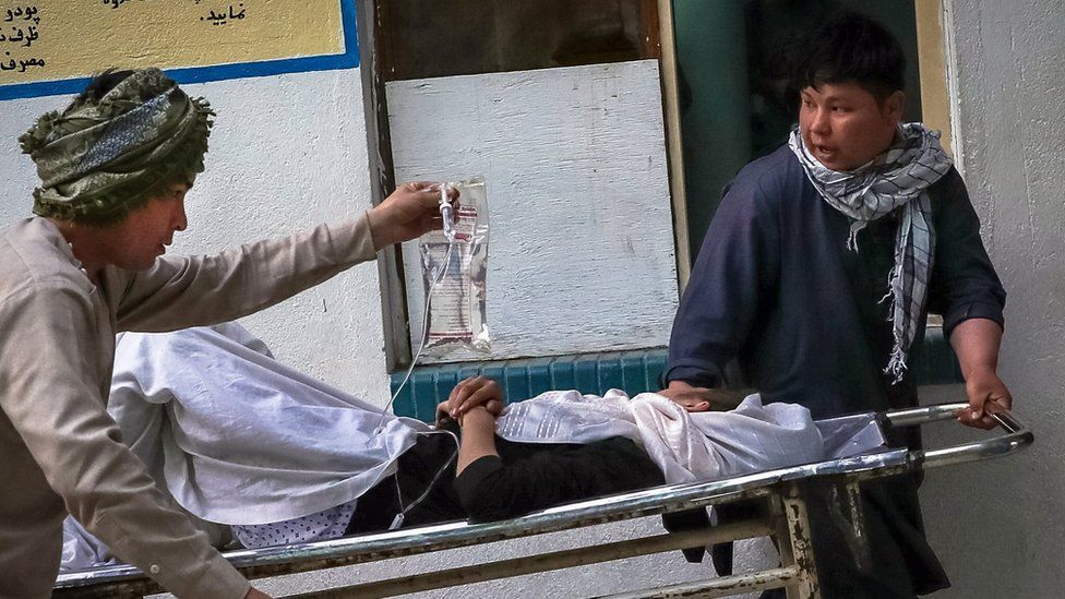 People carry an injured girl into a hospital after an explosion in downtown Kabul, Afghanistan, 08 May 2021.