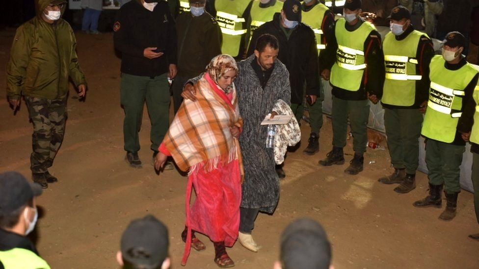 The parents of five-year-old Rayan are seen after rescue workers carried his body to an ambulance in Morocco's Chefchaouen province, 5 February 2022