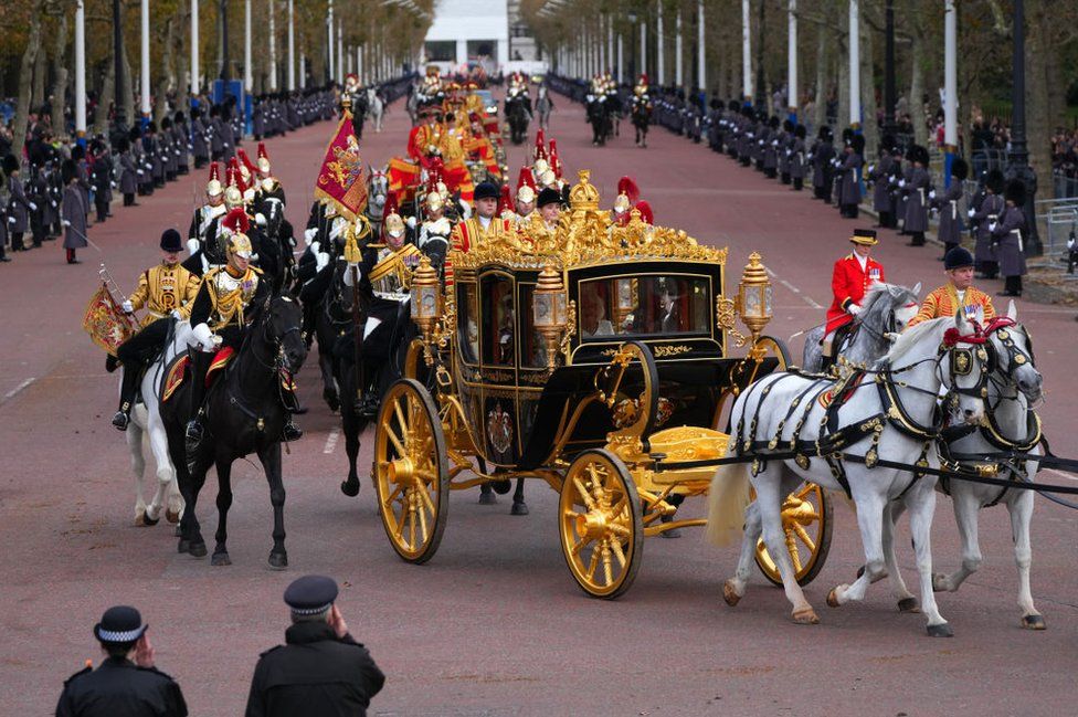 King Charles III and Queen Camilla travel along The Mall towards Buckingham Palace in the Diamond Jubilee State Coach after attending the State Opening of Parliament on November 7, 2023 in London, England.
