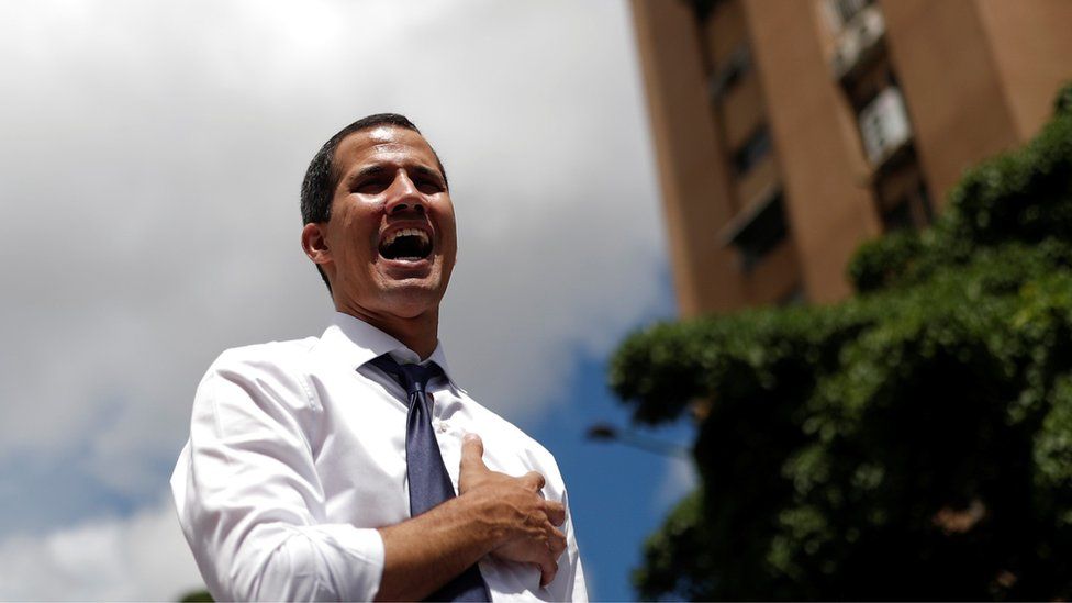 Venezuelan opposition leader Juan Guaido, who many nations have recognised as the country's rightful interim ruler, sings the national anthem during a rally