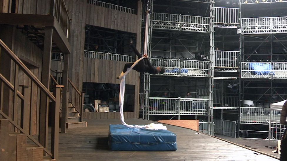 An aerial performer rehearses on stage at Shakespeare's Rose