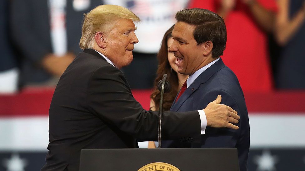 Trump and DeSantis embrace at a rally