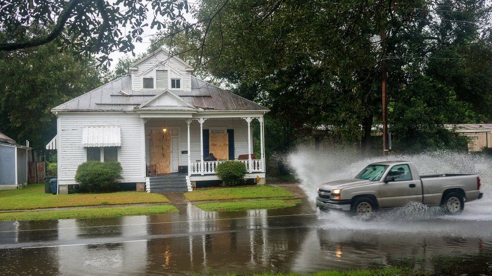 Car driving though flood water in New Iberia, Louisiana
