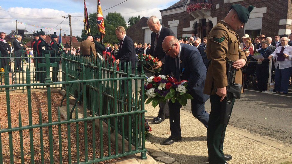 DUP MLA Alastair Ross laying a wreath laying a wreath at the 16th Division Memorial Cross in Guillemont