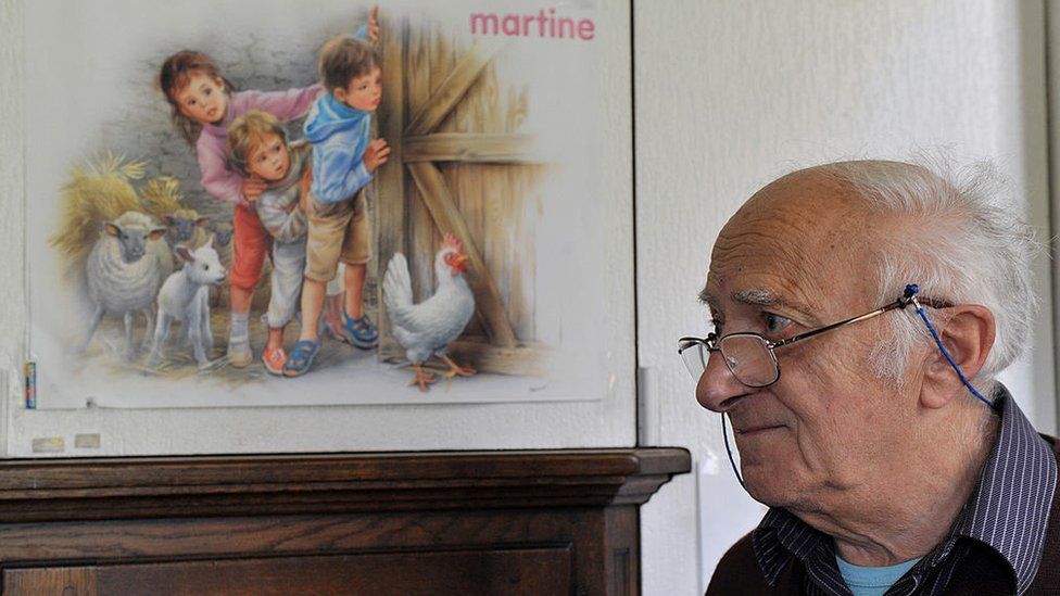 Belgian artist and illustrator Marcel Marlier posing near his drawings of the children's series 'Martine' at his home near Tournay - 2010