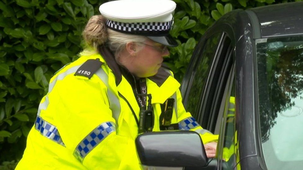An officer speaking to a driver