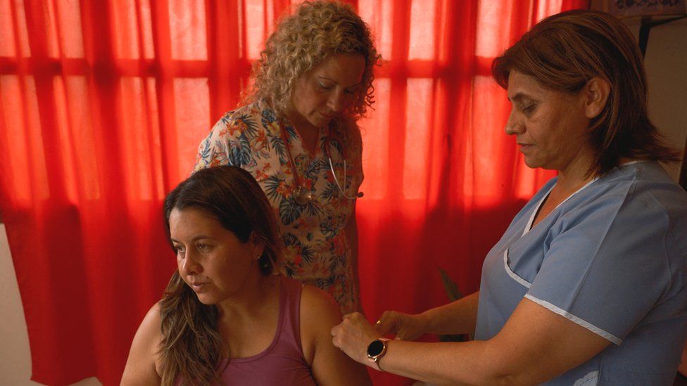A woman receiving a vaccination