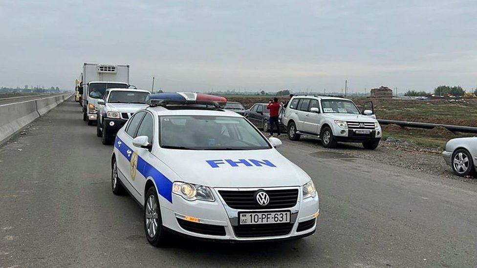 A handout picture made available by the Ministry of Emergency Situations of Azerbaijan shows vehicles deployed by the Ministry of Emergency Situations of Azerbaijan, on their way to deliver humanitarian aid to Armenian civilians in the Karabakh region