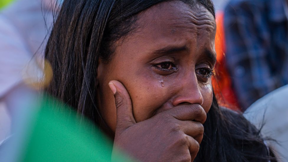 an Ethiopian woman weeps during an event marking the one year anniversary of the war in Tigray in the capital Addis Ababa, Ethiopia - 3 November 2021