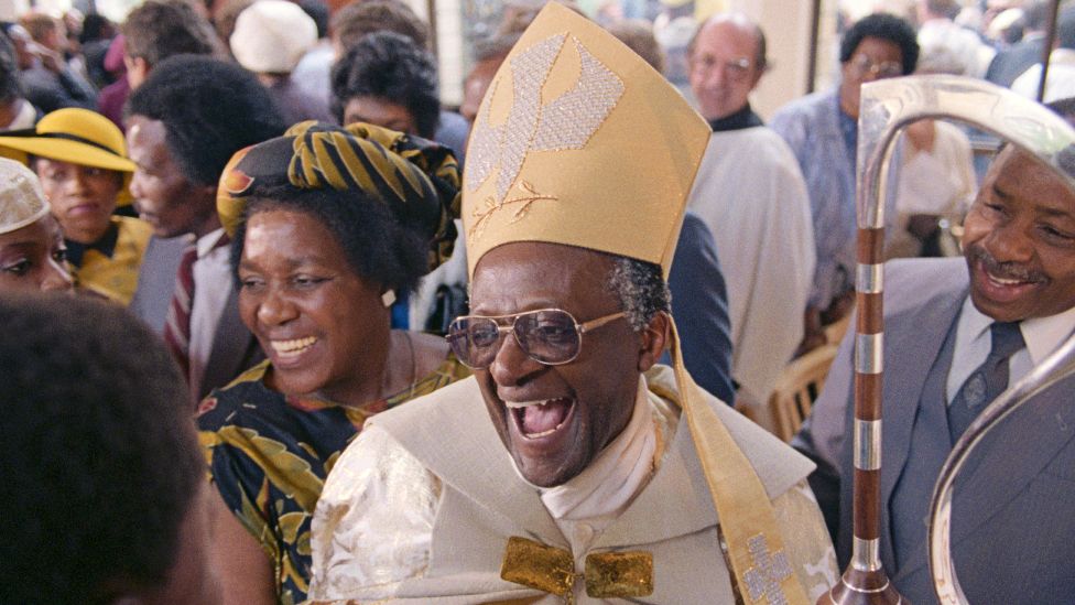 Desmond Tutu smiles after being appointed Anglican Archbishop of Cape Town in 1986, with his wife, Leah, is at his side