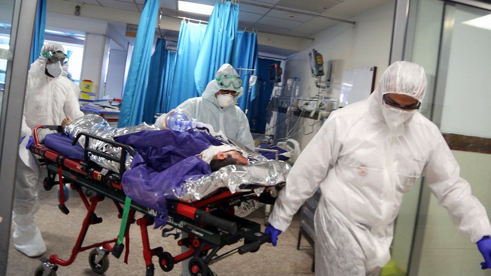 Ambulance staff bring patient into a hospital in Tehran