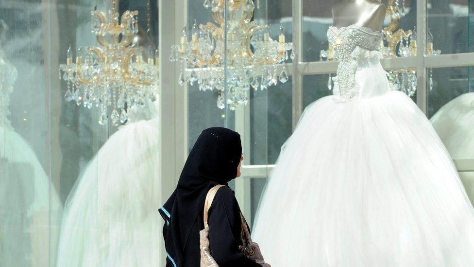 Saudi woman looking at wedding dress