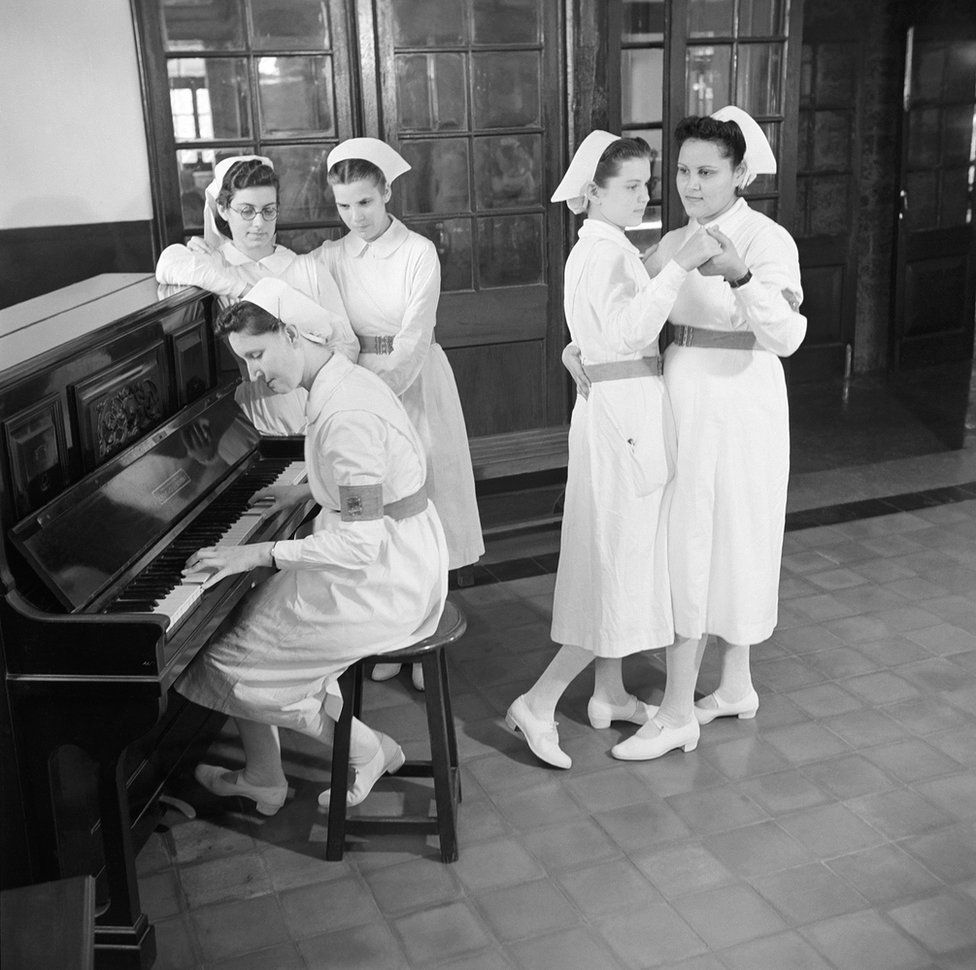 A group of trainee nurses entertain themselves while on a break
