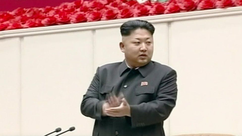 Kim Jung-un on stage, clapping