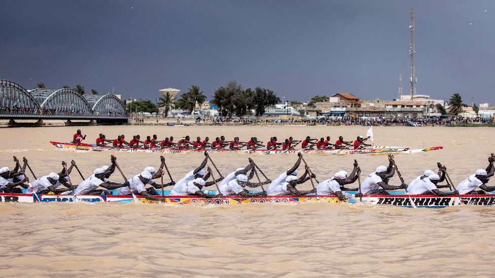 Two pirogue teams race each other along the Senegalese River in Saint-Louis, Senegal - Saturday 23 July 2022