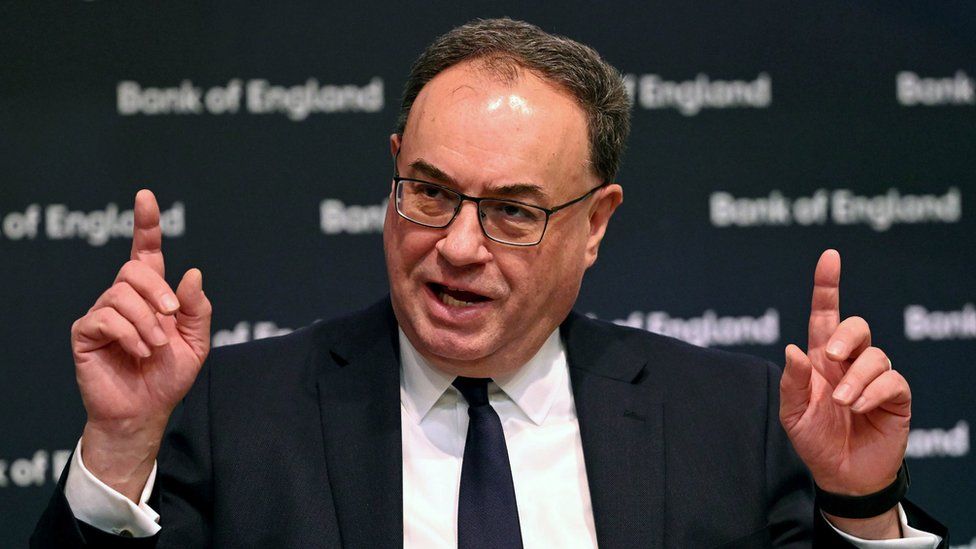 Bank of England governor Andrew Bailey points towards the ceiling